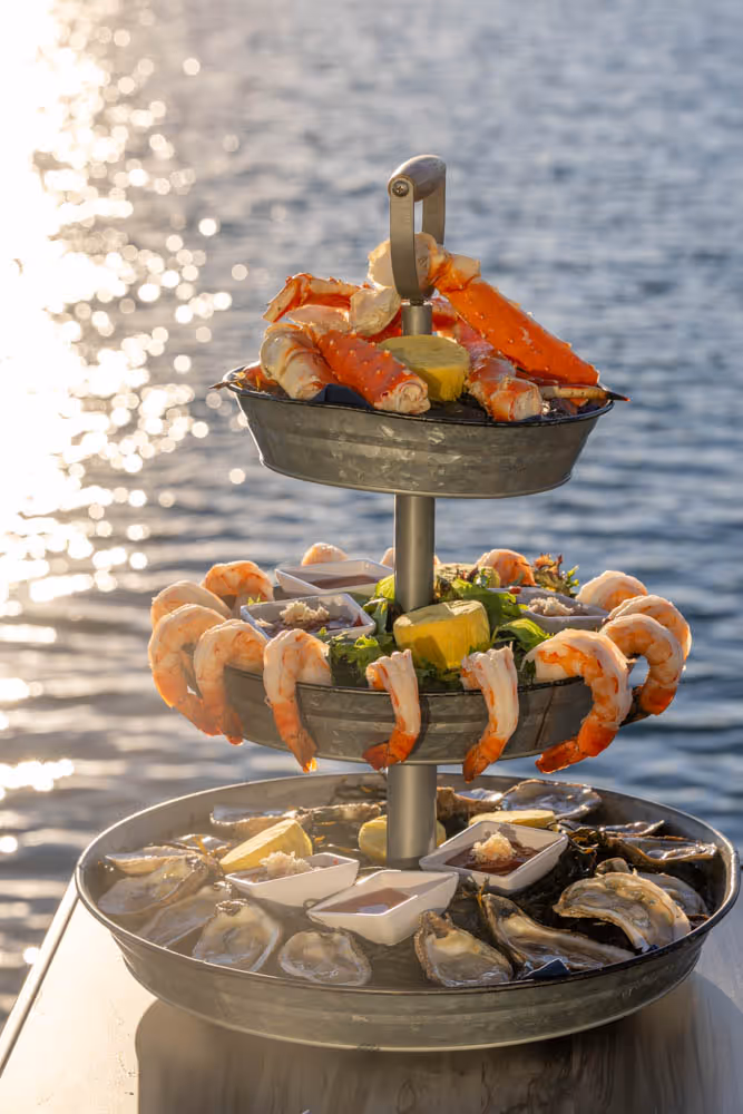 The iced seafood tower at Boathouse on the Bay — oysters, shrimp, crab, and lobster on a bed of crushed ice