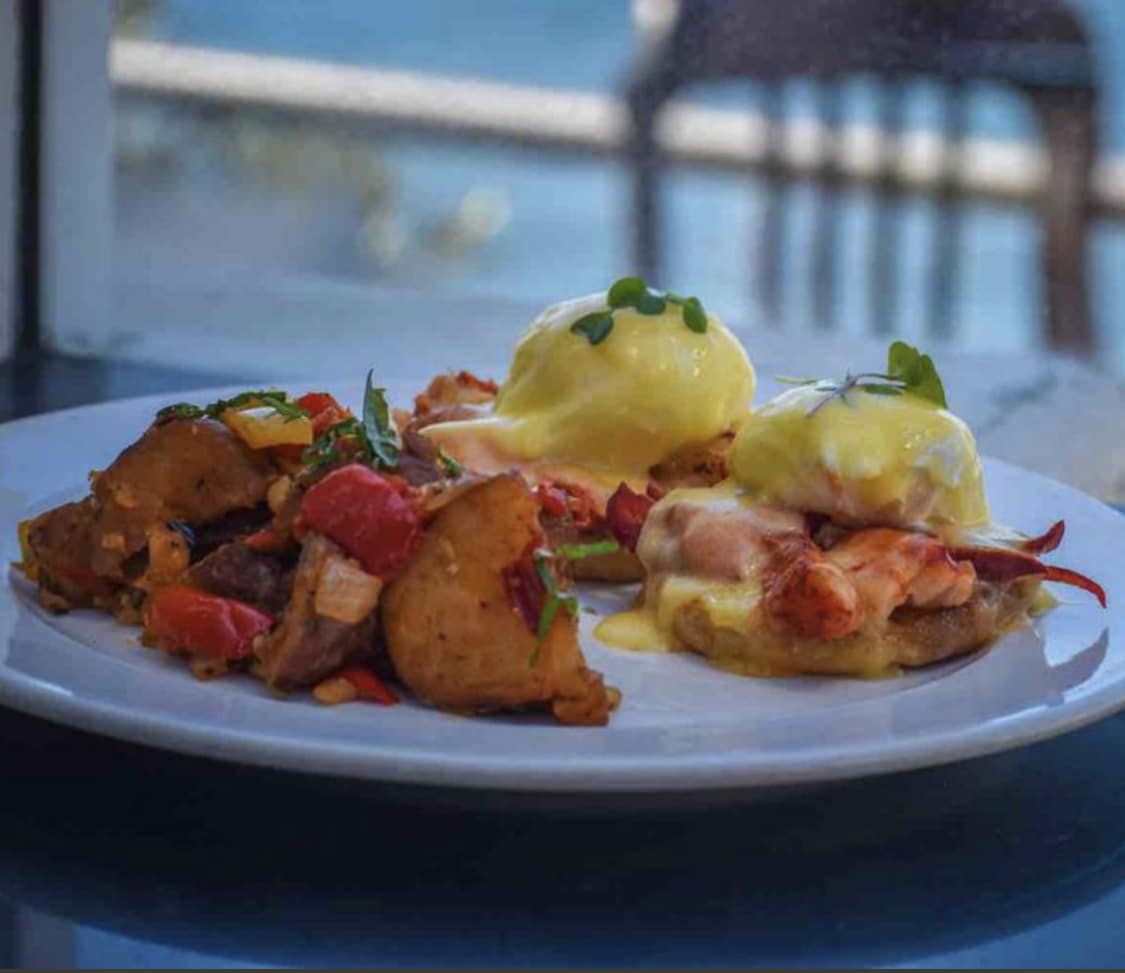 Lobster Benedict at Boathouse on the Bay — Maine lobster claw, poached eggs, hollandaise on toasted English muffins