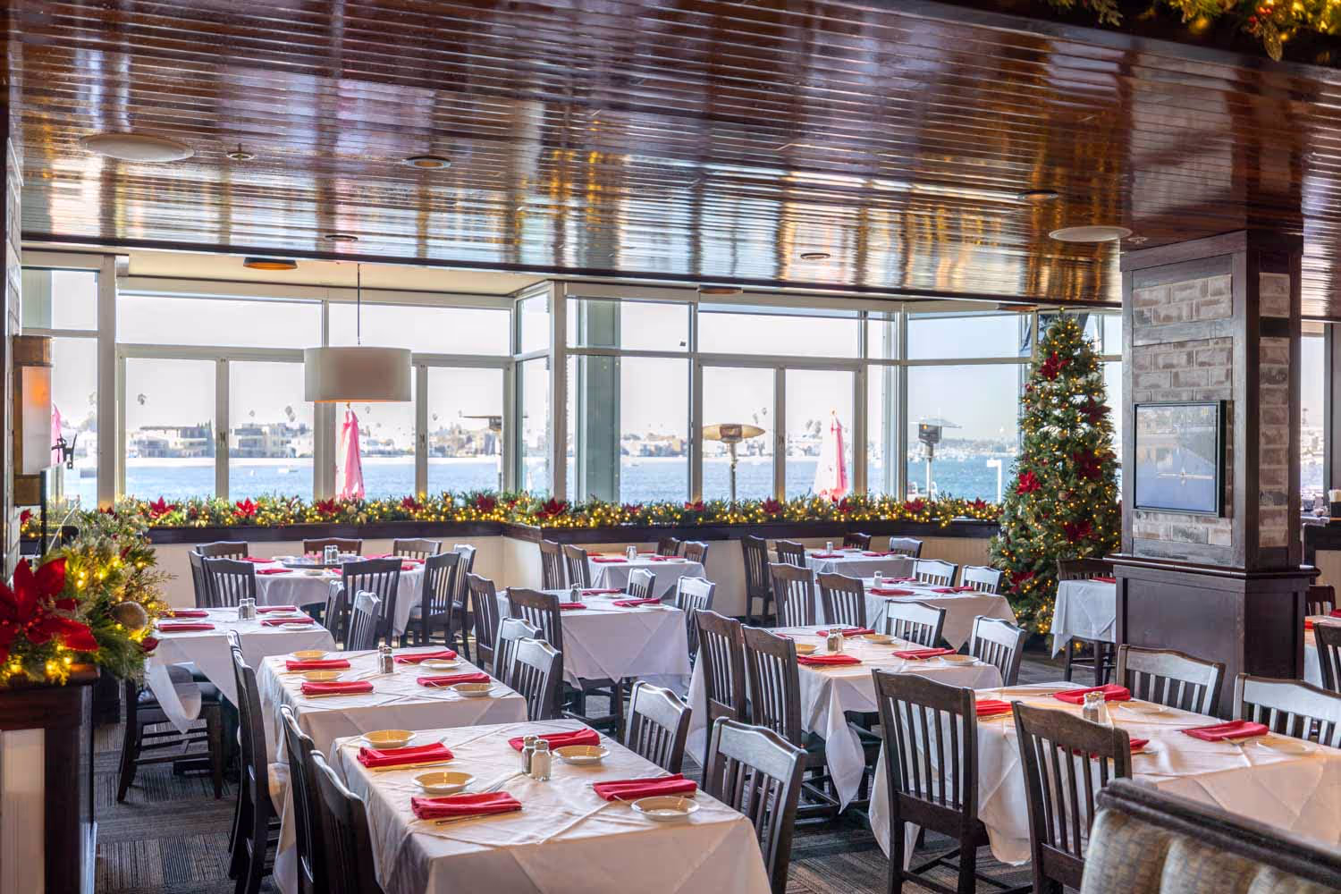 Christmas Eve dinner setup at Boathouse on the Bay with waterfront views and holiday decor